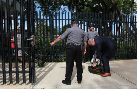 People pass through security outside the federal court building where Puerto Rico's main creditors meet before a U.S. bankruptcy judge, in San Juan, Puerto Rico August 9, 2017. REUTERS/Alvin Baez