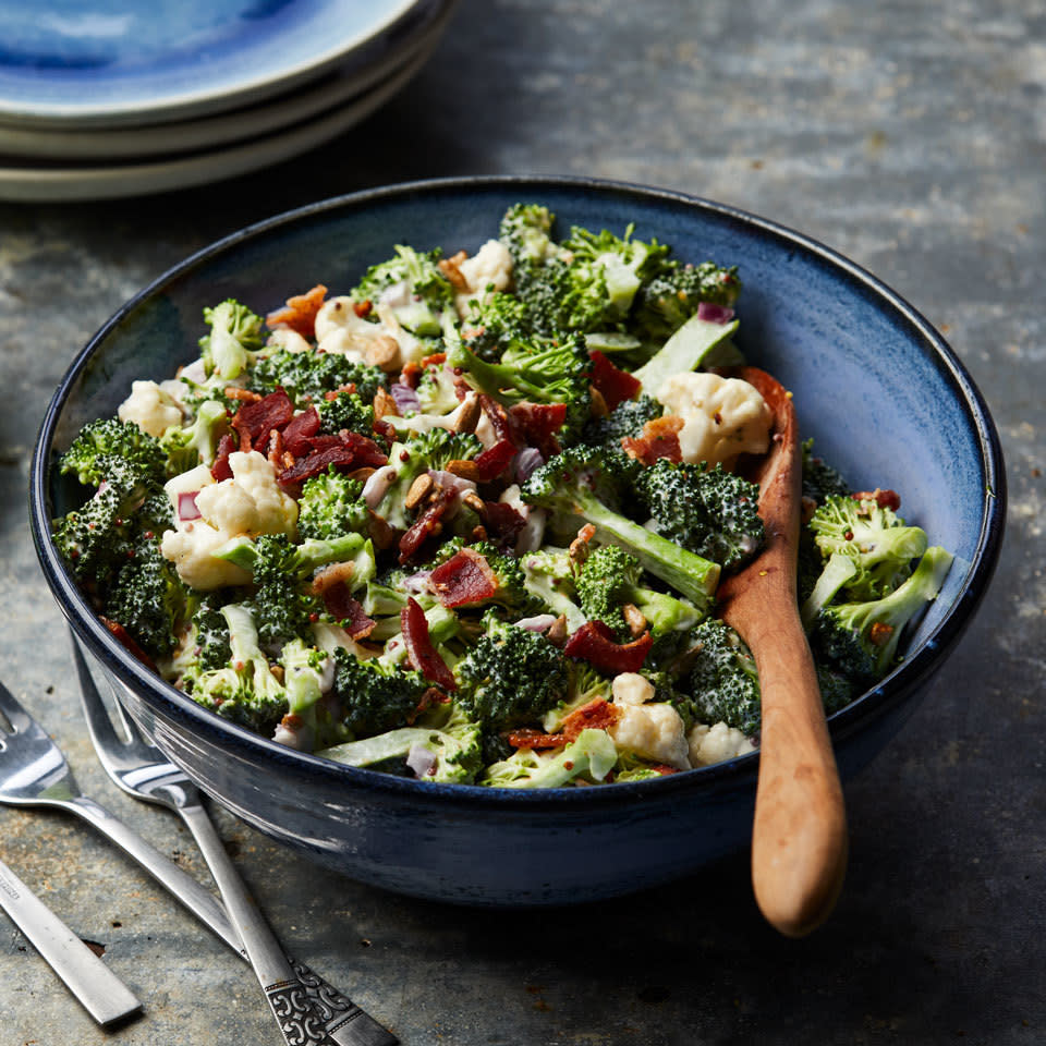 <p>Classic broccoli salad, the perfect dish for a potluck, is updated with cauliflower, bacon and a sprinkle of crunchy sunflower seeds in this so-easy recipe that's sure to be a new picnic favorite. <a href="https://www.eatingwell.com/recipe/262795/broccoli-salad-with-bacon/" rel="nofollow noopener" target="_blank" data-ylk="slk:View Recipe;elm:context_link;itc:0;sec:content-canvas" class="link ">View Recipe</a></p>