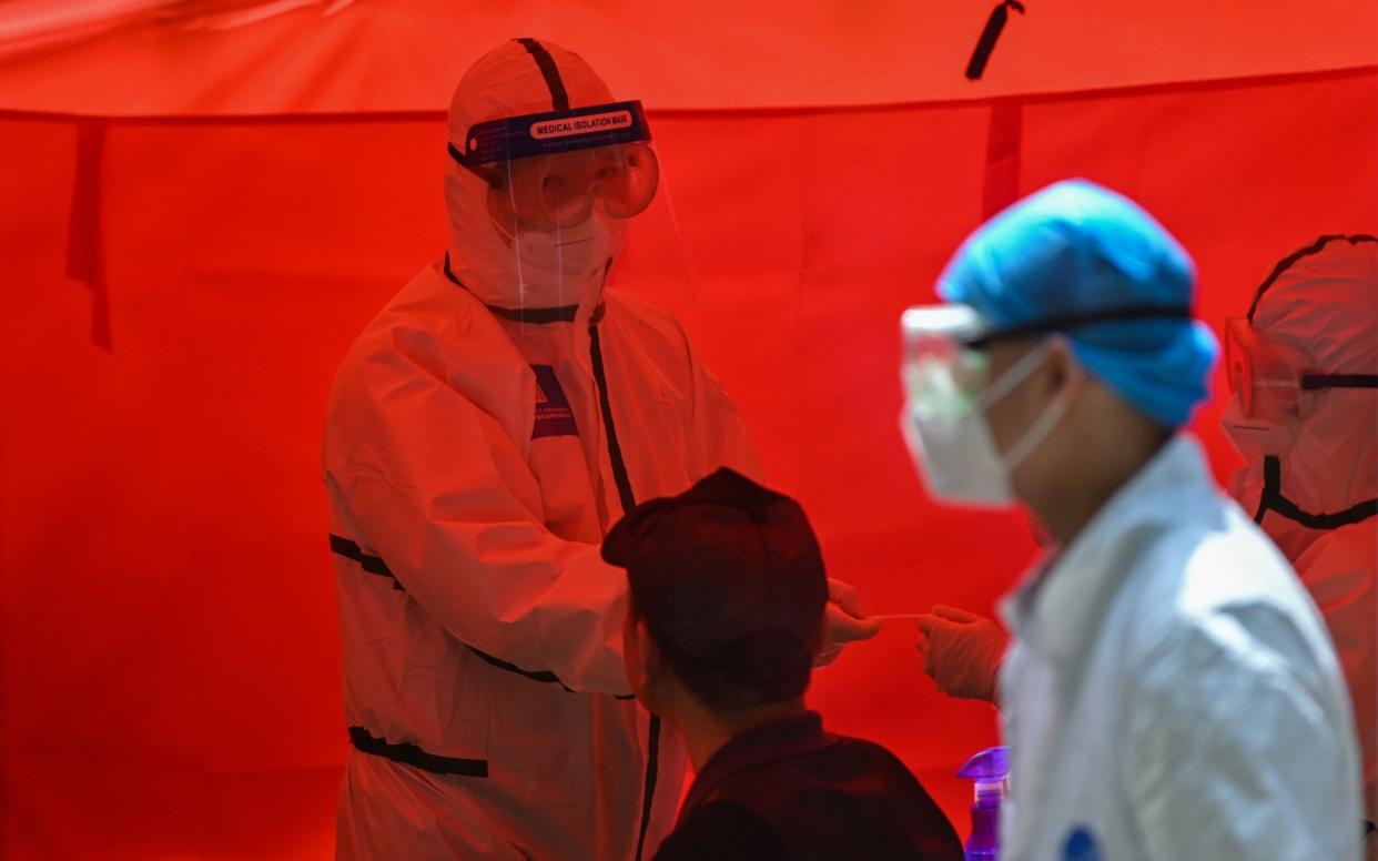 The city of Wuhan tested up to 1.4 million people per day to make sure every citizen was tested - HECTOR RETAMAL/AFP