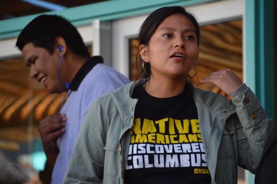 Kimberlaigh Begay, 29, of Albuquerque, N.M., wears a "Native Americans discovered Columbus" t-shirt while attending New Mexico's first Indigenous Peoples Day celebration on Monday, Oct. 14, 2019, at the Indian Pueblo Cultural Center in Albuquerque, N.M. A handful of states celebrated their first Indigenous Peoples Day on Monday as part of a trend to move away from a day honoring Christopher Columbus. (AP Photo/Russell Contreras)