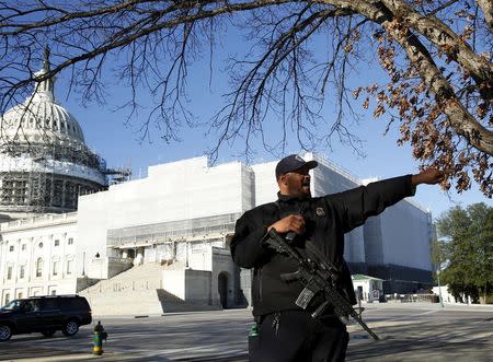 United States Capitol police officer Harry Dunn stops pedestrians in front of the U.S. Capitol in Washington March 29, 2016. REUTERS/Gary Cameron