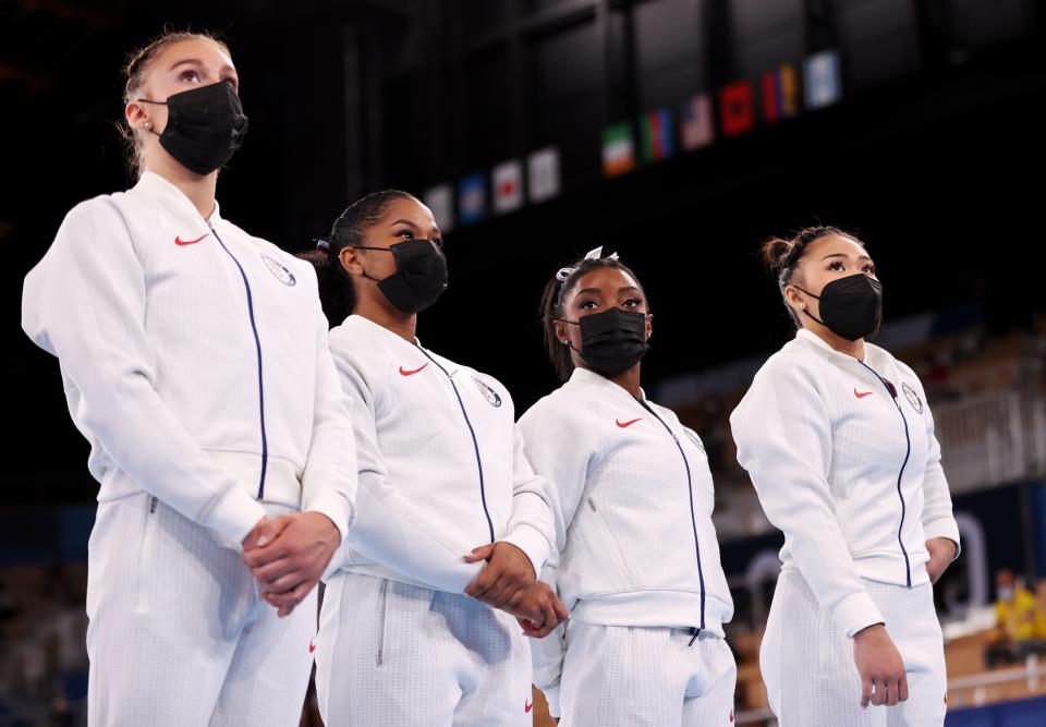 Simone Biles of Team United States looks on with her teammates during the women's team final at the Tokyo Olympics on July 27, 2021. (Laurence Griffiths / Getty Images)