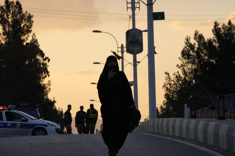A woman walks towards the grave of the late Iranian Revolutionary Guard Gen. Qassem Soleimani in the city of Kerman about 510 miles (820 kms) southeast of the capital Tehran, Iran, Thursday, Jan. 4, 2024. Investigators believe suicide bombers likely carried out an attack on a commemoration for an Iranian general slain in a 2020 U.S. drone strike, state media reported Thursday, as Iran grappled with its worst mass-casualty attack in decades and as the wider Mideast remains on edge. (AP Photo/Vahid Salemi)