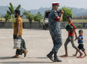 Rohingya refugees arrive at the Chittagong boat club to board naval vessels that will take them to Bhasan Char island, in Chittagong, Bangladesh, Thursday, Nov. 25, 2012. Thousands have been relocated on the island in the Bay of Bengal from crammed camps near the Myanmar border. (AP Photo)