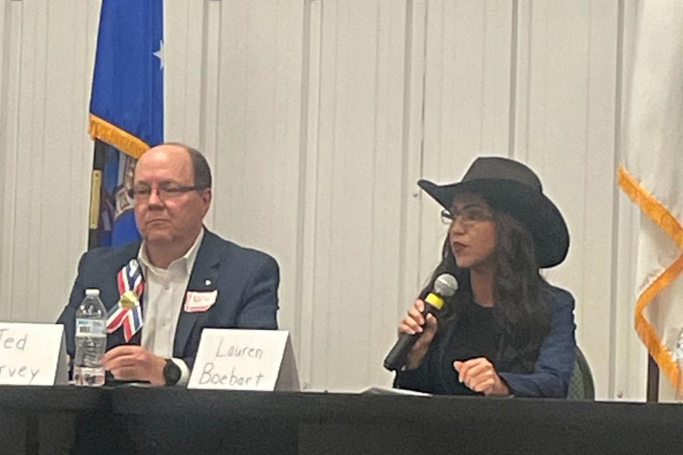 Rep. Lauren Boebert, who represents Colorado’s Third congressional district, is now vying for a seat across the state in CD4 -- where she attended a candidate forum over the weekend and sat behind a misspelt name card at the dais (Sheila Flynn/The Independent)