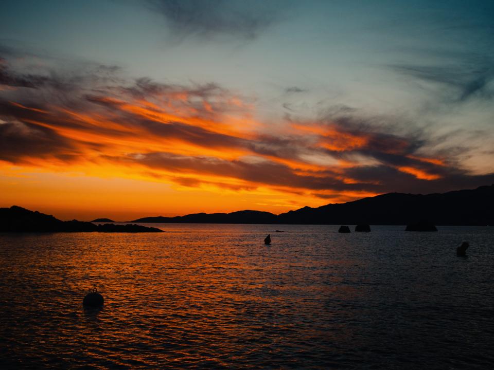 The sun dipping below the horizon on the boat.