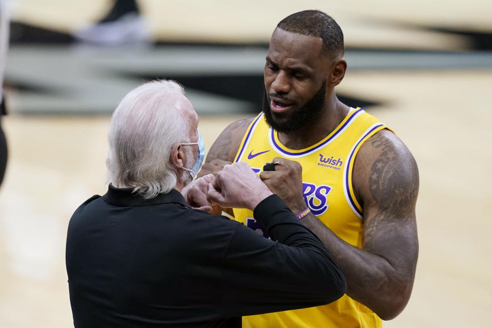 Los Angeles Lakers forward LeBron James, right, greets San Antonio Spurs coach Gregg Popovich before an NBA basketball game in San Antonio, Wednesday, Dec. 30, 2020. (AP Photo/Eric Gay)