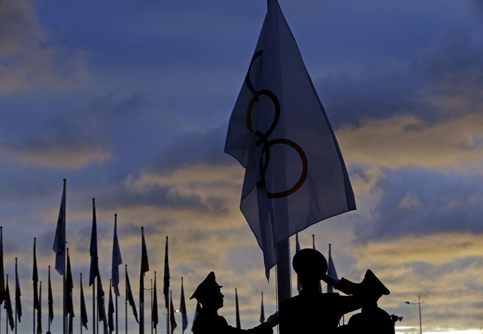 Members of a Russian honor guard raise an Olympic flag during a welcoming ceremony at the 2014 Winter Olympics, Thursday, Feb. 6, 2014, in Sochi, Russia. (AP Photo/Morry Gash)