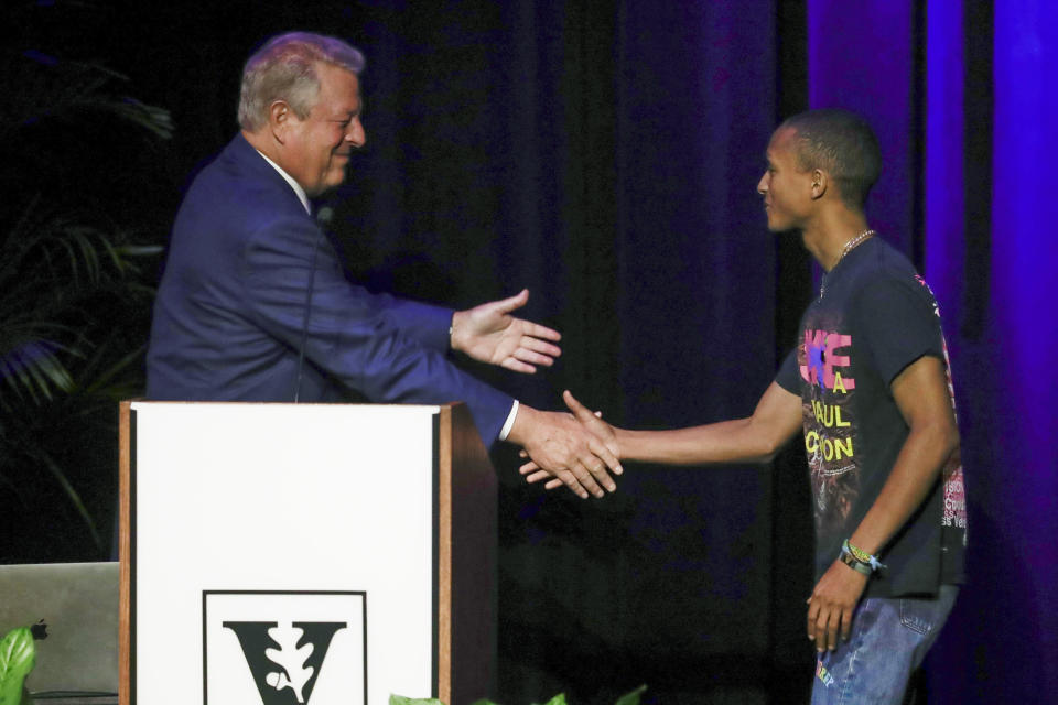 Former Vice President Al Gore welcomes actor and singer Jaden Smith to the stage during Gore's talk on climate change at Vanderbilt University as part of a worldwide event called 24 Hours of Reality: Truth in Action on Wednesday, Nov. 20, 2019, in Nashville, Tenn. (AP Photo/Mark Humphrey)