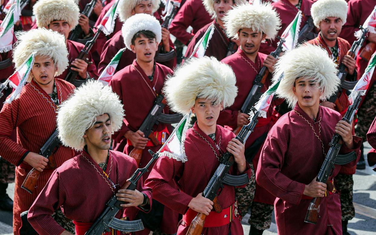 Iranian Turkmen Basij militia members marching during the annual 