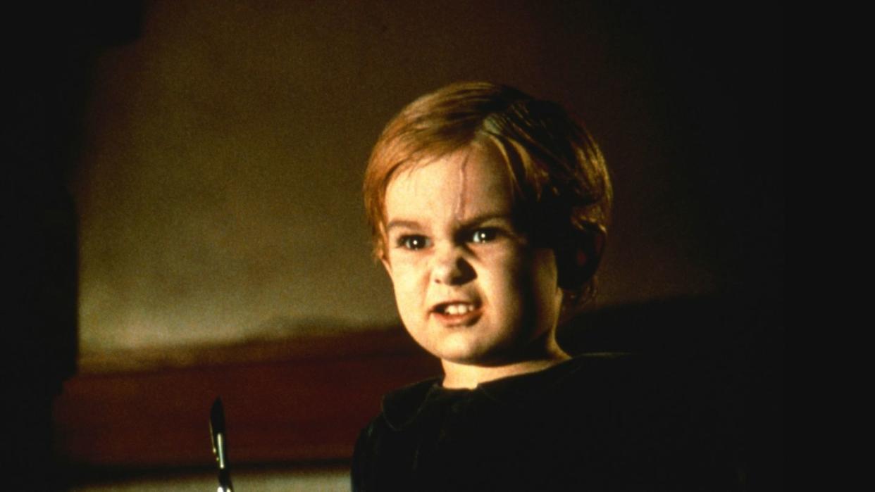 a demonic kid hold a scalpel in a scene from pet semetary, a good housekeeping pick for best halloween movies