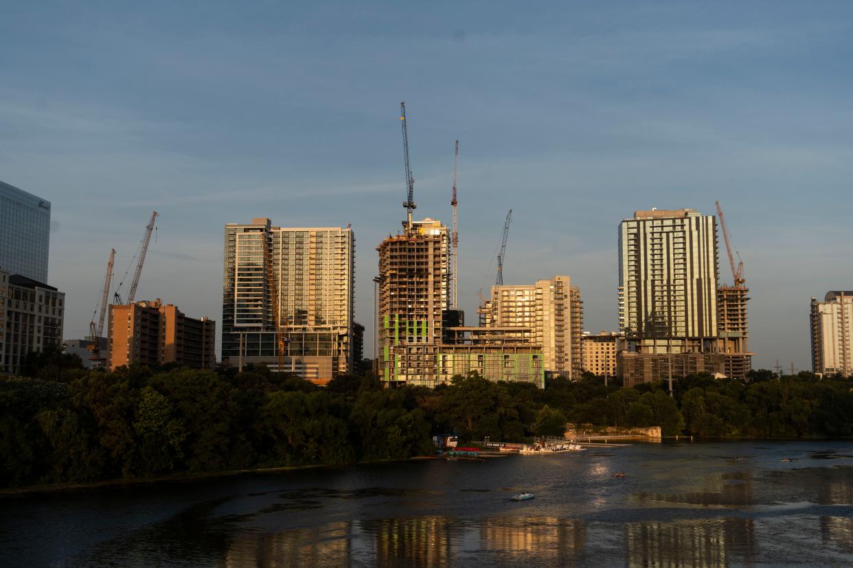 Cranes fill the sky in the Rainey Street area during sunset on July 11. An annual report from the Downtown Austin Alliance found that downtown Austin is better positioned to weather a potential downturn than most city centers across the country.
