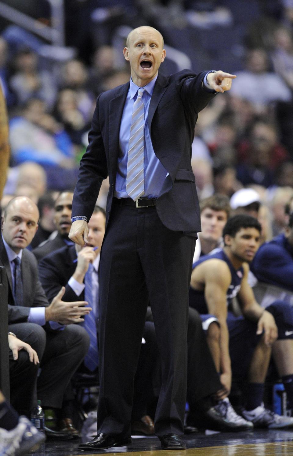 Xavier head coach Chris Mack points during the second half of an NCAA college basketball game against Georgetown, Saturday, Feb. 22, 2014, in Washington. Georgetown won 74-52. (AP Photo/Nick Wass)