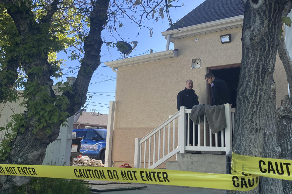 Police stand at the scene of an overnight fire that severely damaged a building that was being renovated to house a new abortion clinic in Casper, Wyoming, Wednesday, May 25, 2022. The clinic, which would also provide other health care for women, had been set to open in June. It would become only the second place in the state to offer abortions. (AP Photo/Mead Gruver)