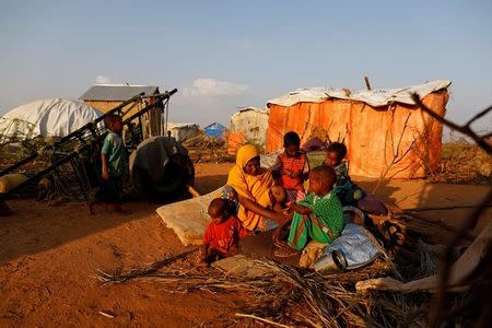 Zeinab's sister Habiba, 29, sits with her children beside their shelter at a camp for internally displaced people from drought hit areas in Dollow, Somalia April 2, 2017. REUTERS/Zohra Bensemra
