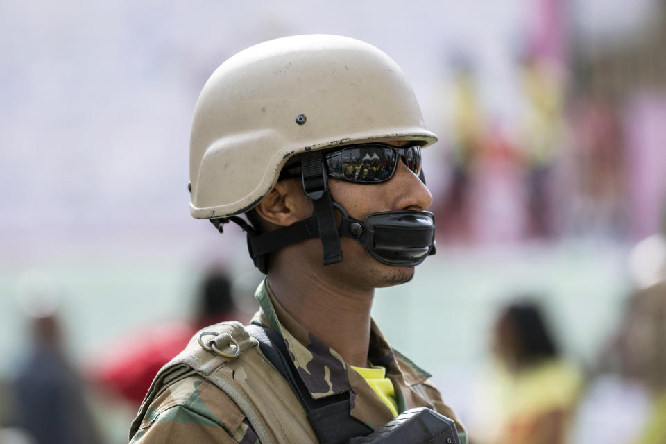 An Ethiopian soldier providing security during a visit by the president to a women's 5km fun run wears his chinstrap as a makeshift face mask to protect against the new coronavirus, in the capital Addis Ababa, Ethiopia Sunday, March 15, 2020. Ethiopia reported on Thursday its first case of the new coronavirus which causes COVID-19. For most people, the new coronavirus causes only mild or moderate symptoms, such as fever and cough but for some, especially older adults and people with existing health problems, it can cause more severe illness, including pneumonia. (AP Photo/Mulugeta Ayene)