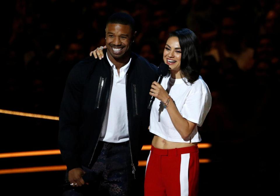 Michael B. Jordan and Mila Kunis speak on stage at the awards (REUTERS)