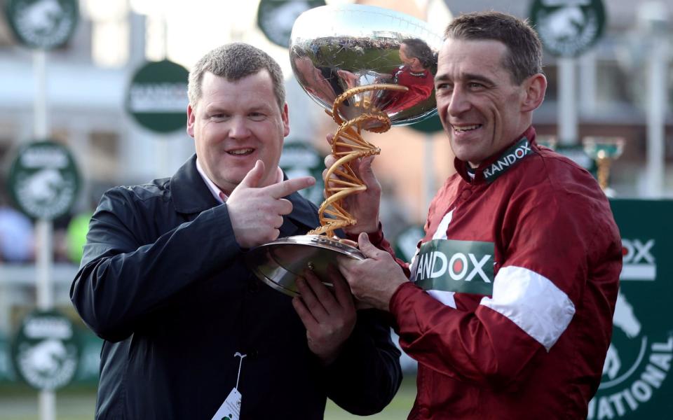 Winning Jockey Davy Russell and trainer Gordon Elliott (left) after winning the Randox Health Grand National Handicap Chase with Tiger Roll during Grand National Day of the 2018  - PA