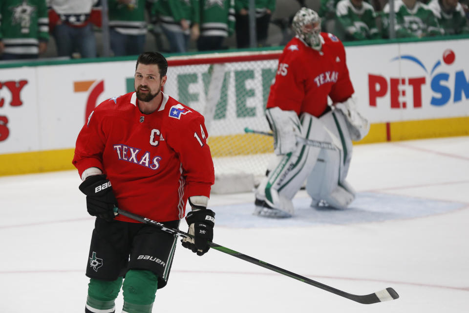 Dallas Stars left wing Jamie Benn, wears a baseball style jersey during warm-ups on Texas Rangers Night before an NHL hockey game against the Tampa Bay Lightning in Dallas, Monday, Jan. 27, 2020. (AP Photo/Ray Carlin)