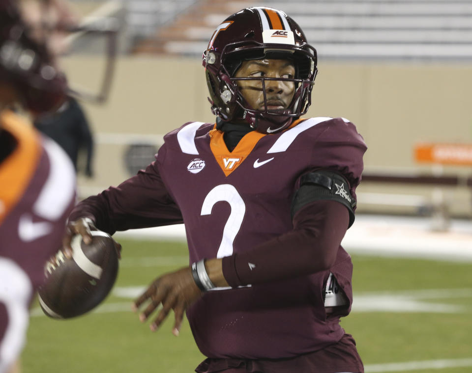 Virginia Tech's Hendon Hooker warms up for the team's NCAA college football game against Clemson on Saturday, Dec. 5, 2020, in Blacksburg, Va. (Matt Gentry/The Roanoke Times via AP, Pool)