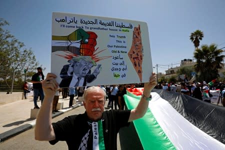 FILE PHOTO: Palestinian demonstrator holds anti-Trump sign during a rally marking the 71st anniversary of the 'Nakba' in Ramallah in the Israeli-occupied West Bank