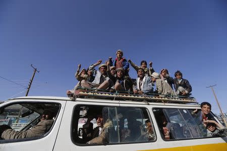 Followers of the Houthi group ride a bus to a rally at the main stadium in Sanaa, February 7, 2015. REUTERS/Khaled Abdullah