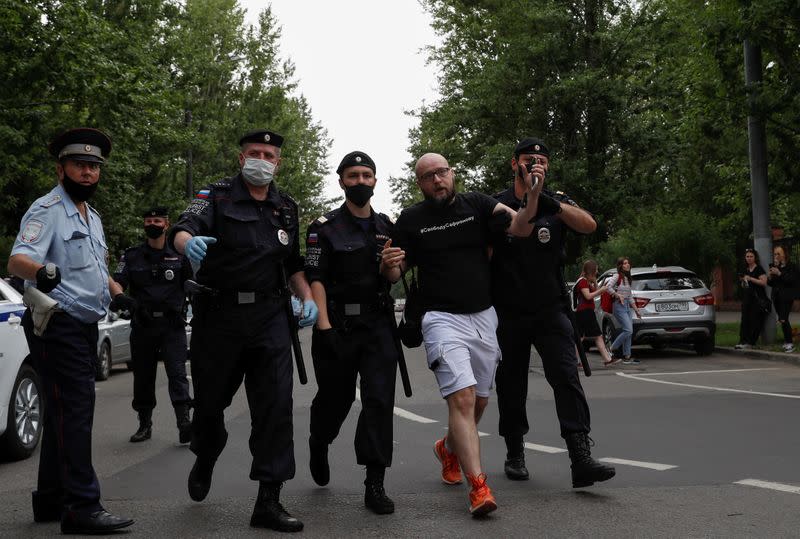 Policemen detain a participant of a picket in support of former journalist Ivan Safronov in Moscow