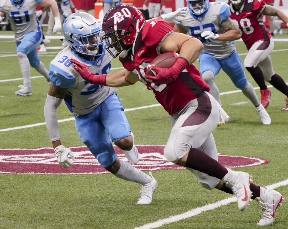 San Antonio Commanders' Kenneth Farrow II (20) attempts to evade Salt Lake Stallions' Henre' Toliver during the second half of an AAF football game, Saturday, March 23, 2019, at the Alamodome in San Antonio. San Antonio won 19-15. (AP Photo/Darren Abate)