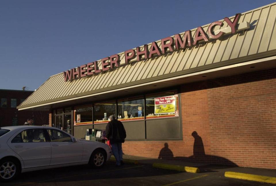 Customers enter Wheeler’s Pharmacy as it opens at 9 a.m., where a regular crowd enjoys breakfast together in Lexington, Ky., on 1/4/02. Herald-Leader File