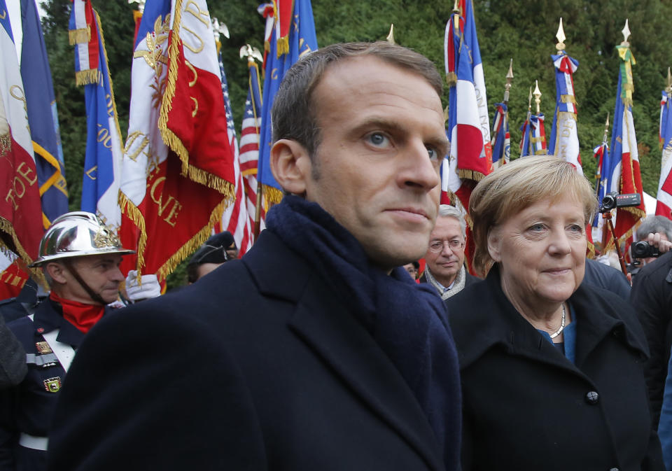 French President Emmanuel Macron, center, and German Chancellor Angela Merkel attend a ceremony in Compiegne, north of Paris, Saturday, Nov. 10, 2018. The leaders of France and Germany have held an intimate commemoration at the site north of Paris where the vanquished Germans and victorious but exhausted Allies put an end to World War I. ( AP Photo/Michel Euler)