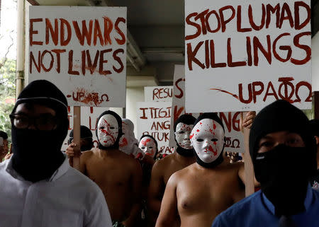 Naked mebers of the Alpha Phi Omega (APO) fraternity wearing masks attend a protest against extrajudicial killings and the lifting of martial law in the southern island of Mindanao, at the University of the Philippines in Quezon city, Metro Manila, Philippines December 1, 2017. REUTERS/Dondi Tawatao