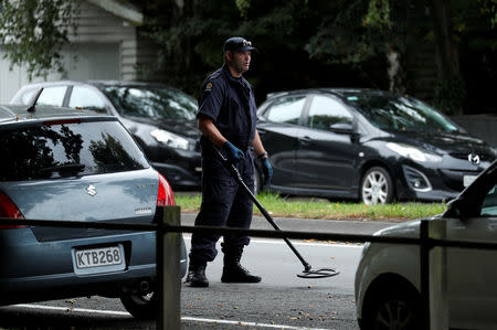 A police officer looks for explosive devices near Masjid Al Noor mosque in Christchurch, New Zealand, March 17, 2019. REUTERS/Jorge Silva