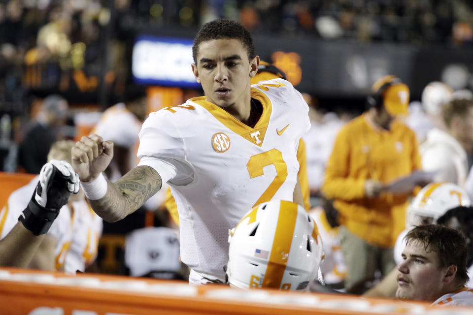 Tennessee quarterback Jarrett Guarantano bumps fists with teammates on the sideline in the second half of an NCAA college football game against Vanderbilt Saturday, Nov. 24, 2018, in Nashville, Tenn. Vanderbilt won 38-13. (AP Photo/Mark Humphrey)