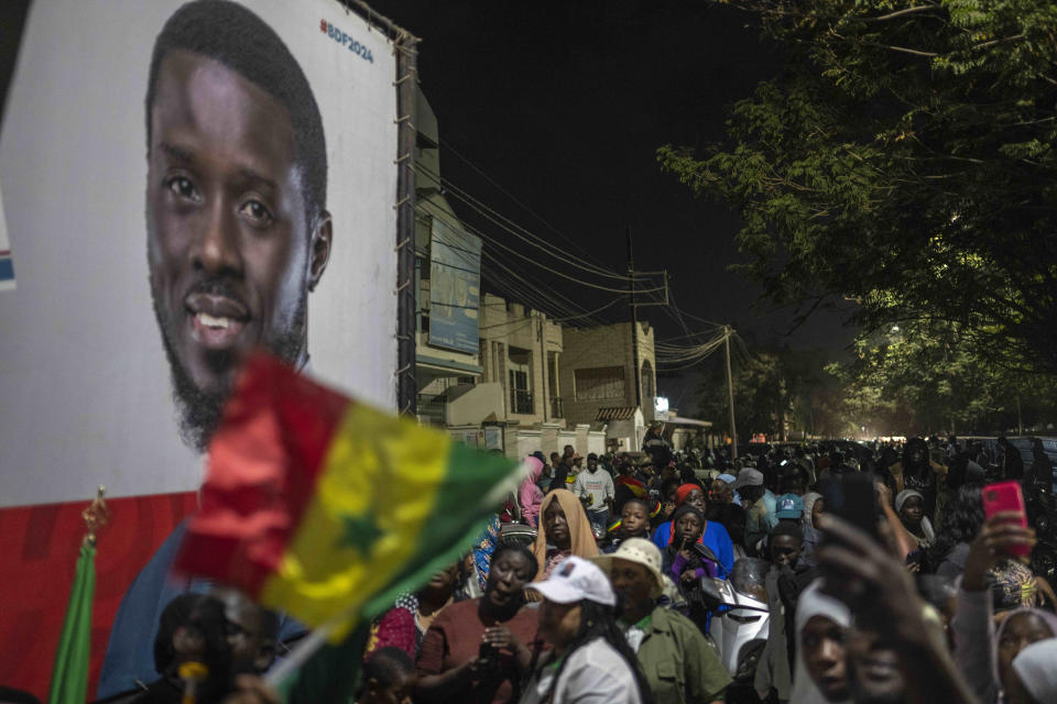 Supporters of presidential candidate Bassirou Diomaye Faye gather outside his campaign headquarters as they await the results of the presidential election, in Dakar, Senegal, Sunday, March 24, 2024. (AP Photo/Mosa'ab Elshamy)