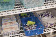 Moderna and Pfizer COVID-19 vaccines sit in a refrigerator at a mass-vaccination site at the former Citizens Bank headquarters in Cranston, R.I., Thursday, June 10, 2021. The U.S. is confronted with an ever-growing surplus of COVID-19 vaccines, looming expiration dates and stubbornly lagging demand at a time when the developing world is clamoring for doses to stem a rise in infections. (AP Photo/David Goldman)