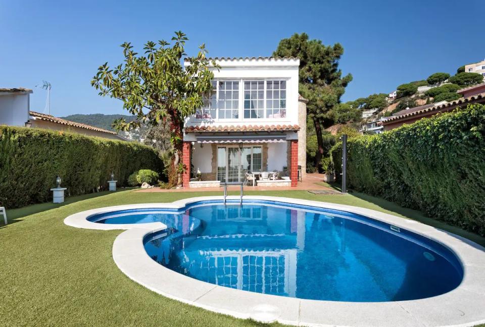 a swimming pool in front of a house