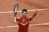 Serbia's Novak Djokovic celebrates towards the crowd after defeating Lithuania's Ricardas Berankis during their third round match on day 7, of the French Open tennis tournament at Roland Garros in Paris, France, Saturday, June 5, 2021. (AP Photo/Thibault Camus)