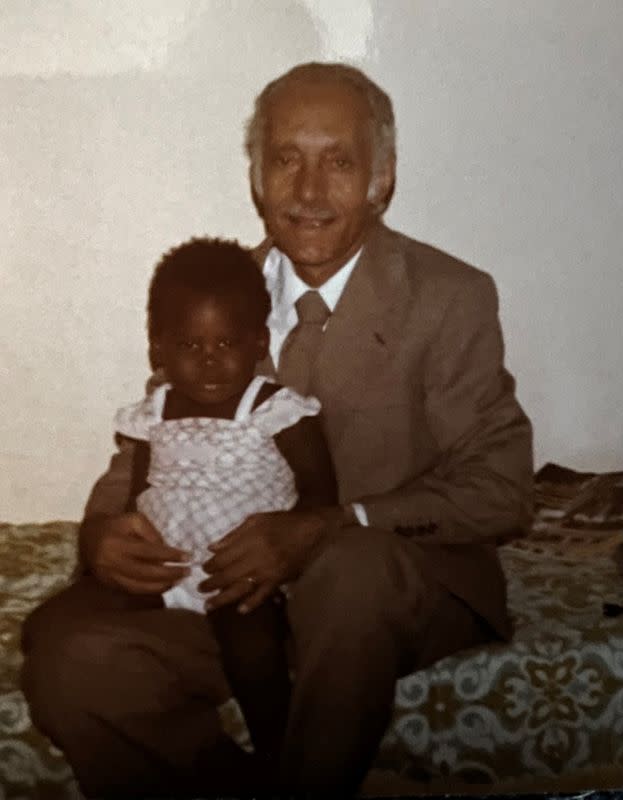 An undated handout image shows Kholoud Yagoob Abdallah when she was a toddler with her adopted family member in Khartoum An undated handout image shows a Sudanese woman trapped in Khartoum