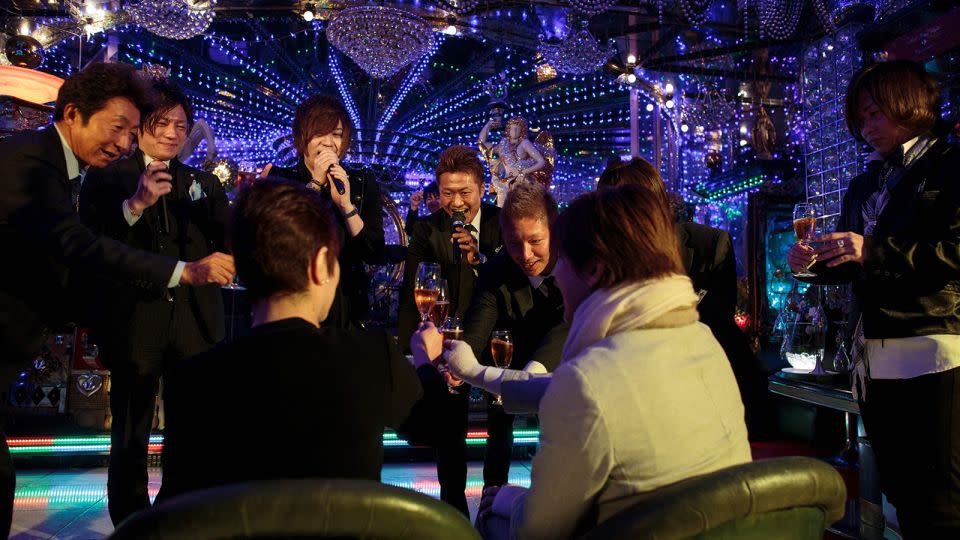 Male hosts drink champagne with a customer in a host club in Kabukicho, Tokyo, in January 2017. - Behrouz Meheri/AFP/Getty Images