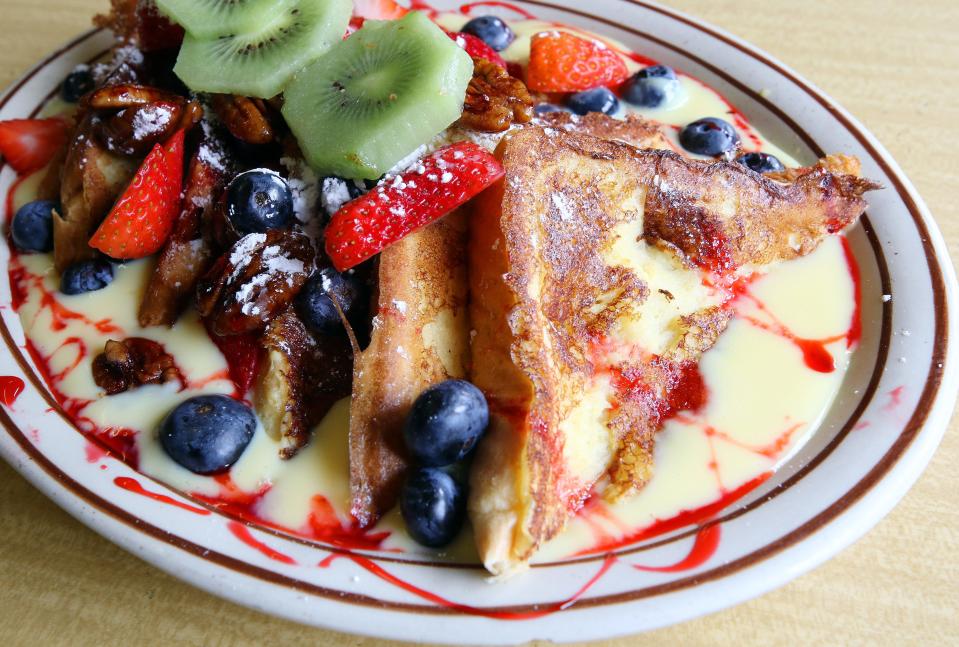 The Modern Diner's version of French toast sits on a pool of custard and is crowned with fresh fruit and raspberry sauce.