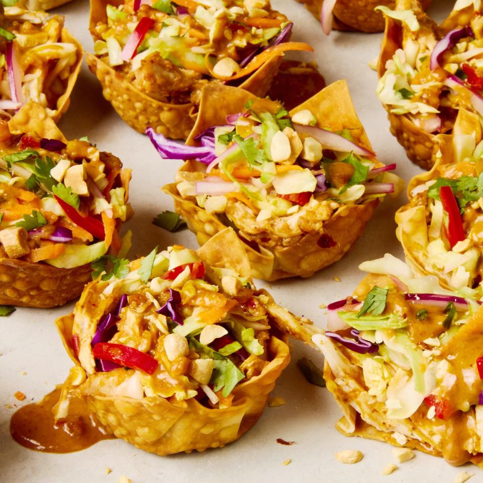 shredded rotisserie chicken gets tossed in a spicy sweet peanut sauce, stuffed in a crispy baked wonton shell, and topped with bright, colorful, and crunchy veggies to make this easy two bite app