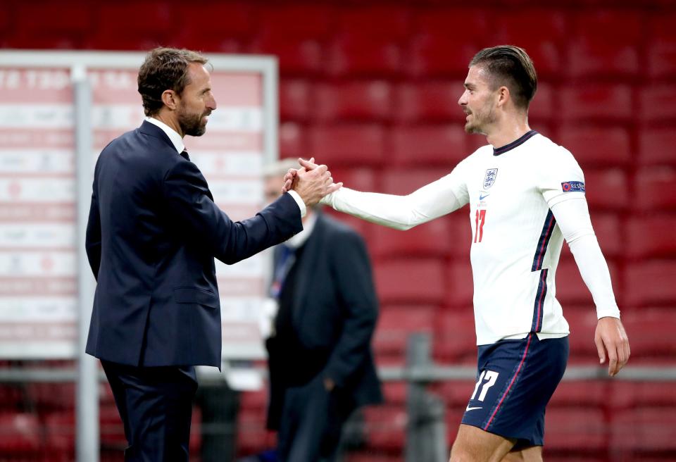 Jack Grealish shakes hands with manager Gareth Southgate (PA)