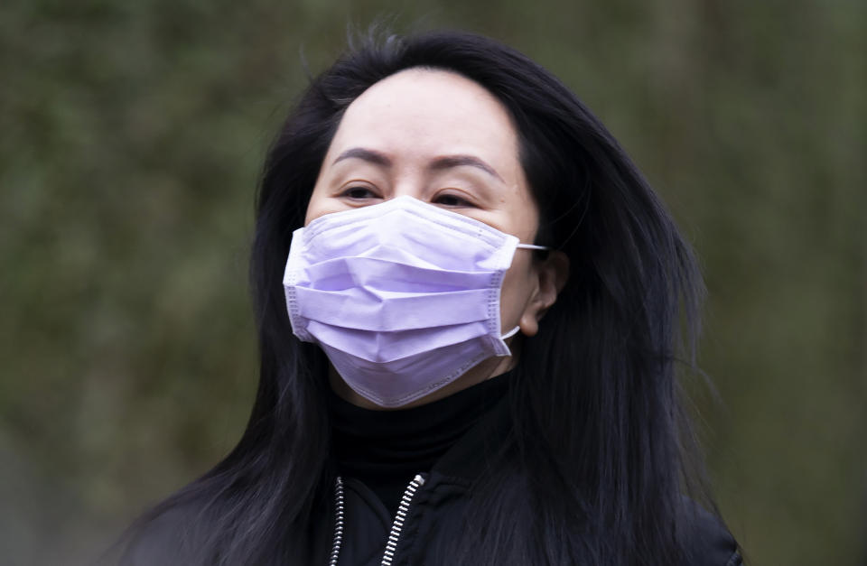 Chief Financial Officer of Huawei, Meng Wanzhou leaves her home in Vancouver, British Columbia, to go to the British Columbia Supreme Court on Friday, Jan. 29, 2021. (Jonathan Hayward/The Canadian Press via AP)