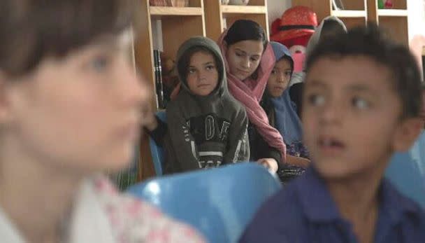 PHOTO: A teacher gives lessons to Zarlasht and other children in Salam Cafe. (ABC News)