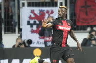 Leverkusen's Victor Boniface celebrates after scoring his side's second goal during the Europa League quarterfinals first leg soccer match between Bayer 04 Leverkusen and West Ham United at the BayArena in Leverkusen, Germany, Thursday, April 11, 2024. (AP Photo/Martin Meissner)