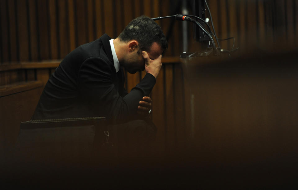 Oscar Pistorius, puts his hands to his head while listening to evidence from a witness speaking about the morning of the shooting of his girlfriend Reeva Steenkamp, on the fourth day of his trial at the high court in Pretoria, South Africa, Thursday, March 6, 2014. Pistorius is charged with murder for the shooting death of his girlfriend, Steenkamp, on Valentines Day in 2013. (AP Photo/Werner Beukes, Pool)