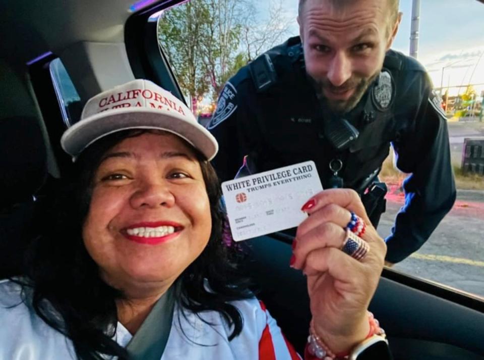 Mimi Israelah shared a selfie of herself and the officer smiling together as she proudly flashed the card to the camera (Facebook)