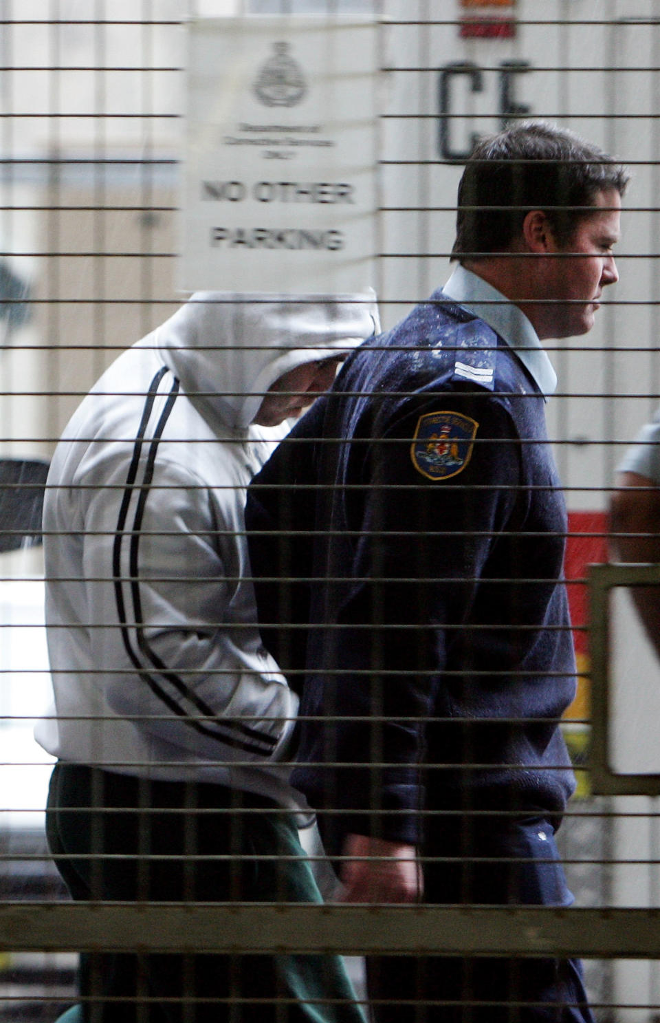 Hells Angels member Peter Zervas is led by police in to Central Local Court on July 9, 2009 in Sydney, Australia. (Photo by Lisa Maree Williams/Getty Images)