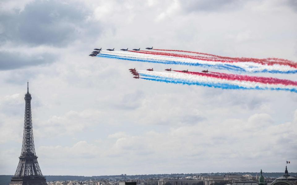 France's elite flying team "Patrouille de France" and Britain's Royal Air Force's "Red Arrows" perform fly past