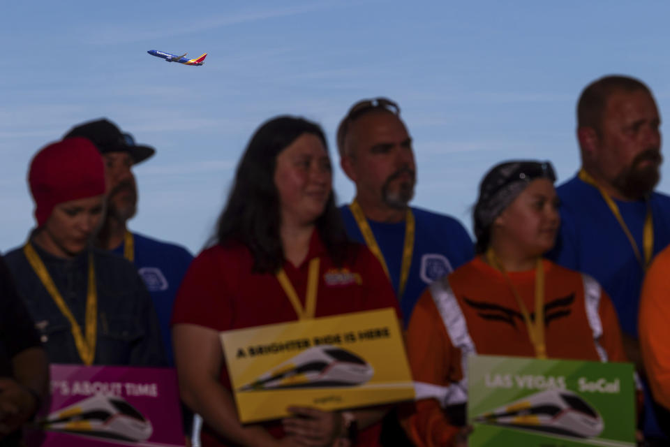 A plane takes off behind a groundbreaking for a high-speed passenger rail on Monday, April 22, 2024, in Las Vegas. A $12 billion high-speed passenger rail line between Las Vegas and the Los Angeles area has started construction. (AP Photo/Ty ONeil)